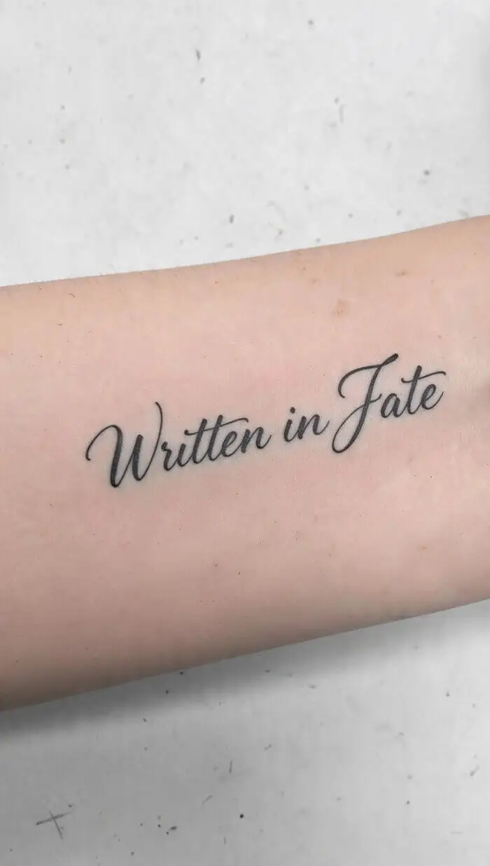 "Written in Fate" Quote Tattoo – Beautiful Script Forearm Ink Design