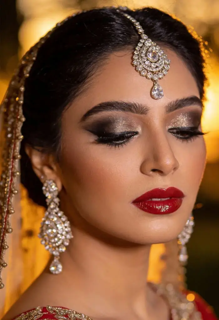 Classic Red Bridal Makeup with Gold Smokey Eyes and Statement Jewelry
