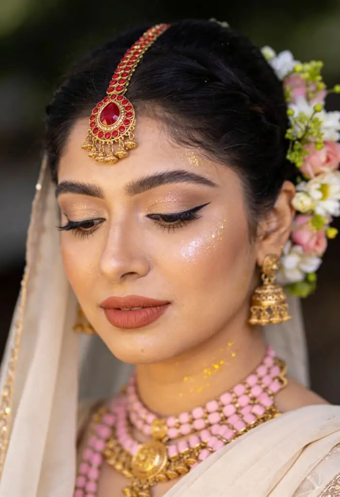 Elegant South Indian Bridal Makeup with Gold Glow & Pink Temple Jewelry