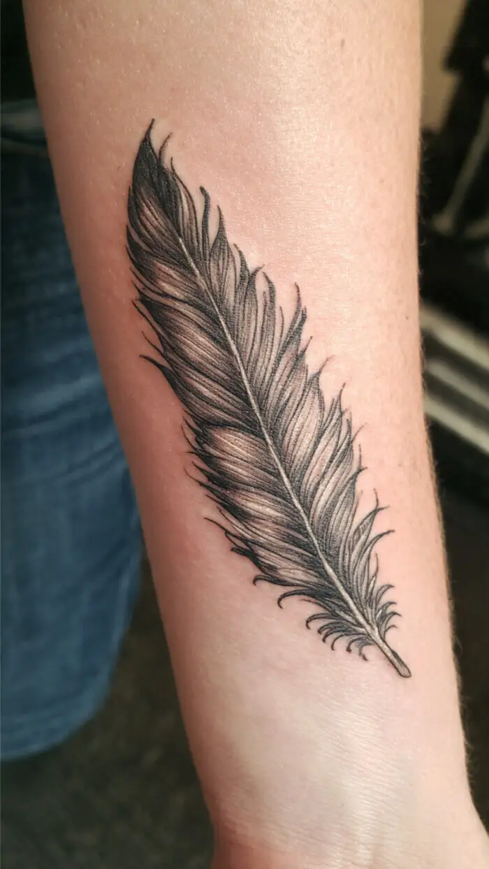 Minimalist Feather Tattoo Design on Forearm