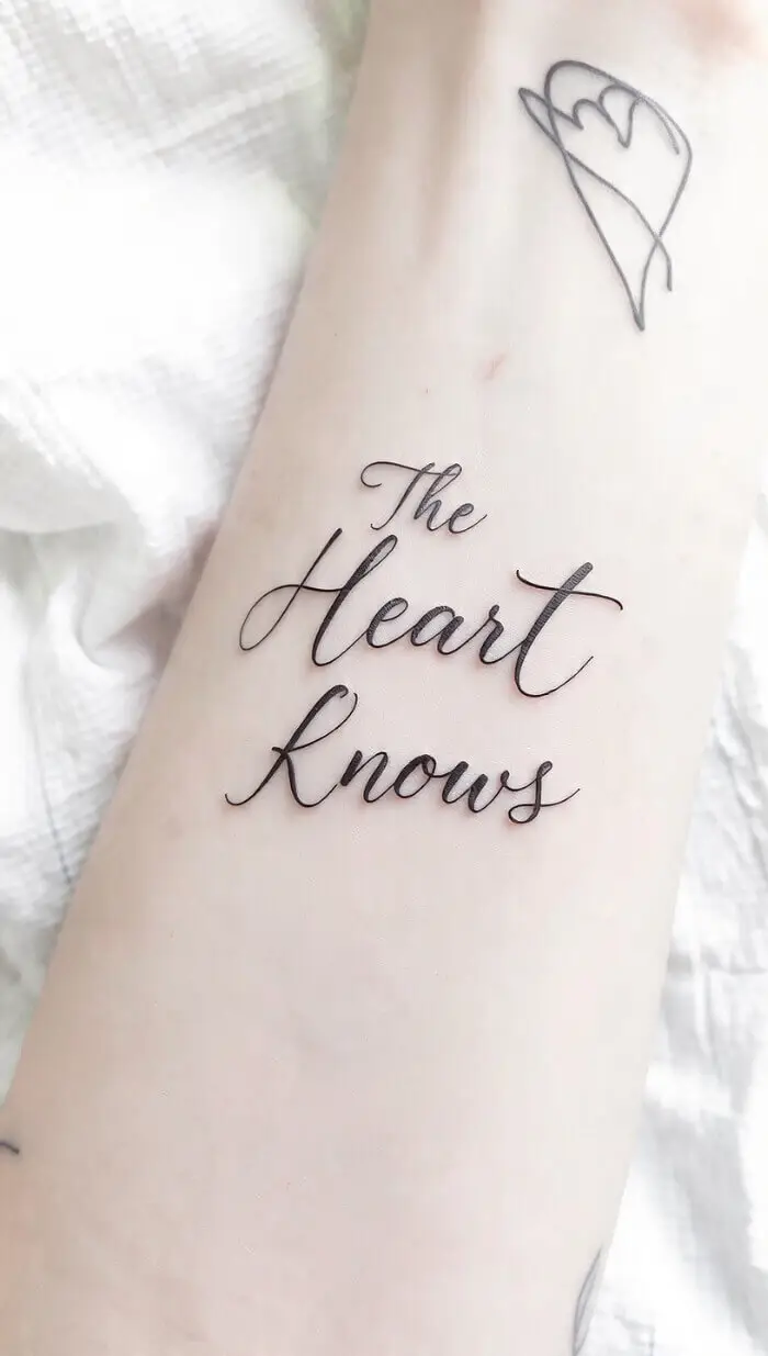 "The Heart Knows" Tattoo – Elegant Script Quote Tattoo Design