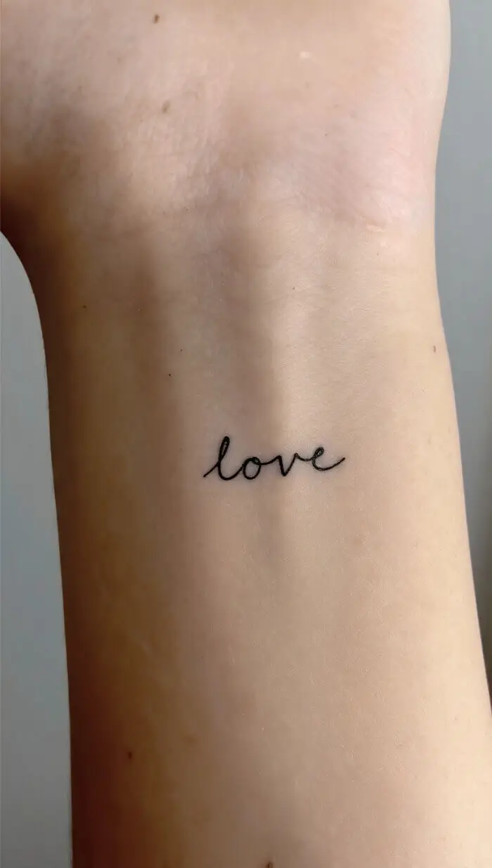Simple "Love" Script Wrist Tattoo Design