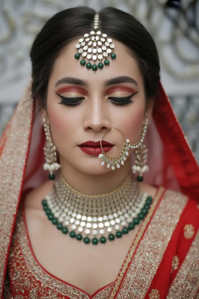 Beautiful Indian Bride Makeup Look with Gold & Emerald Jewelry