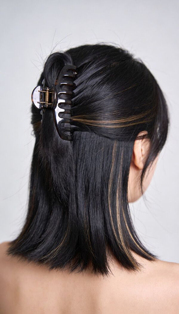 Half up hairstyle with claw clip for short hair