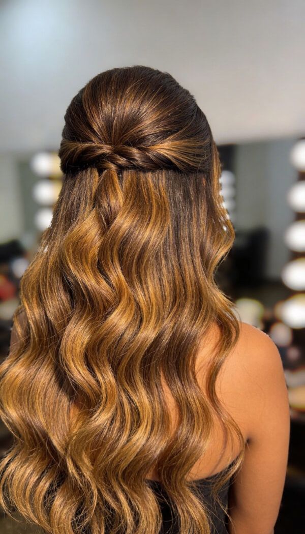 Half up half down hairstyle with soft waves and braided detail